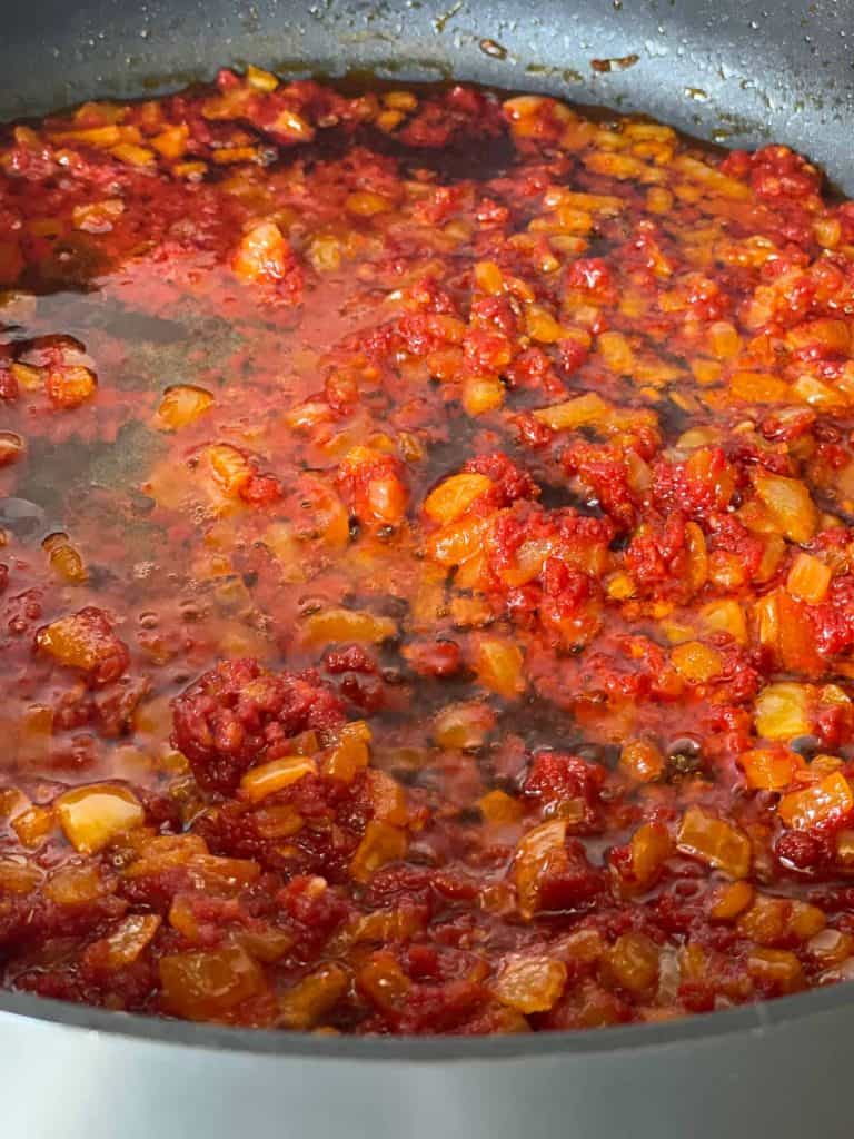 Stir in tomato paste.