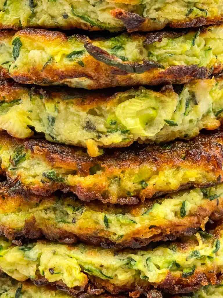 A stack of zucchini fritters freshly made.