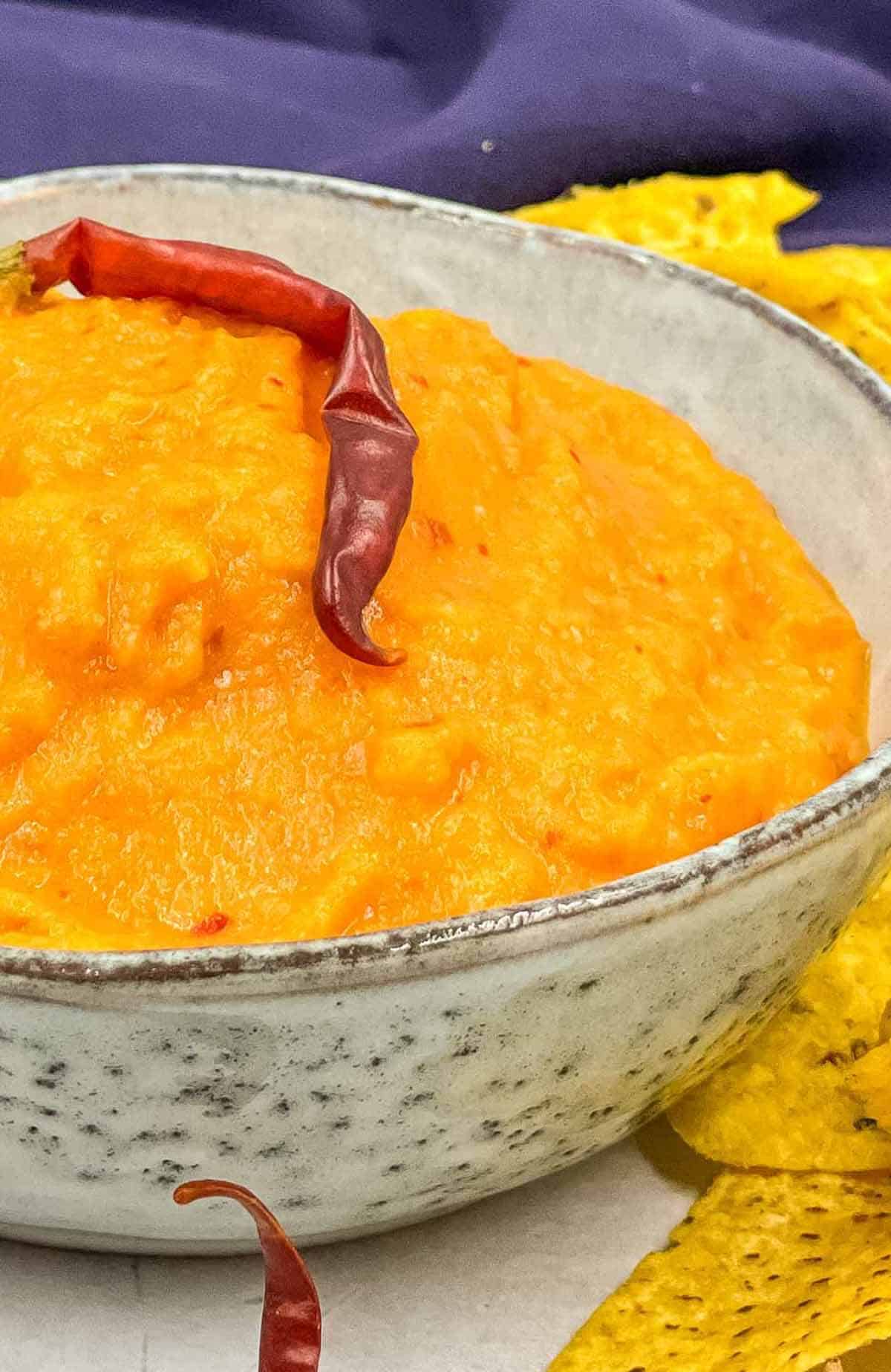 A bowl of homemade salsa taquera with an Arbol chili on top.