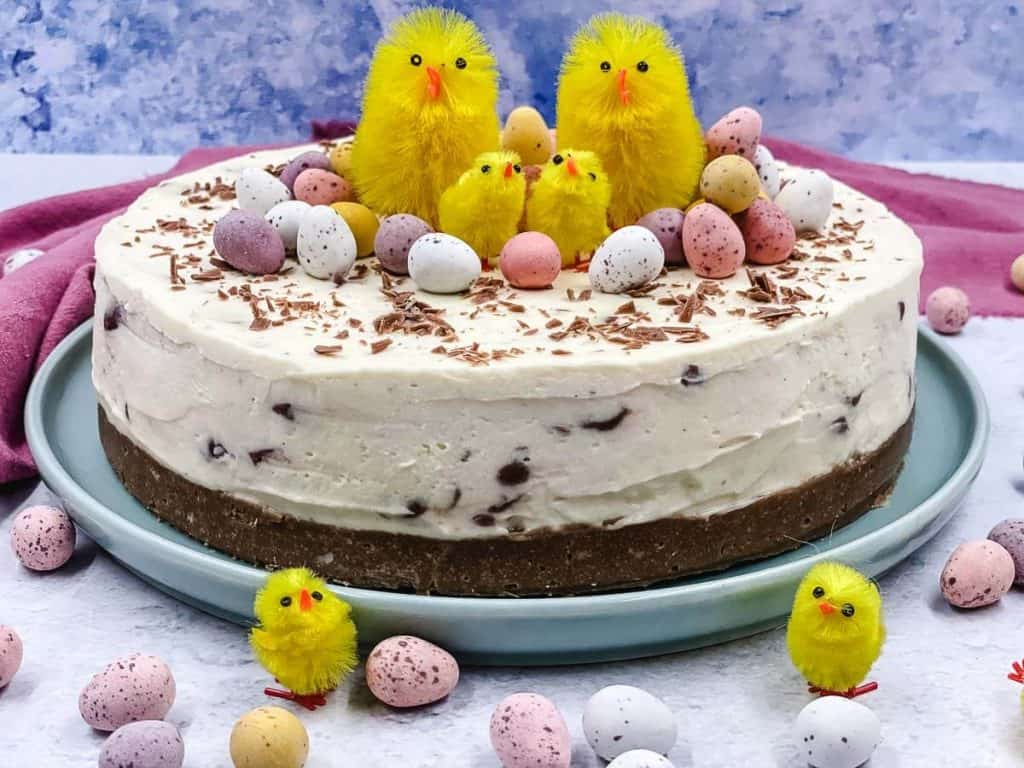 Beautiful cheesecake with multi colored mini eggs, and chicks.
