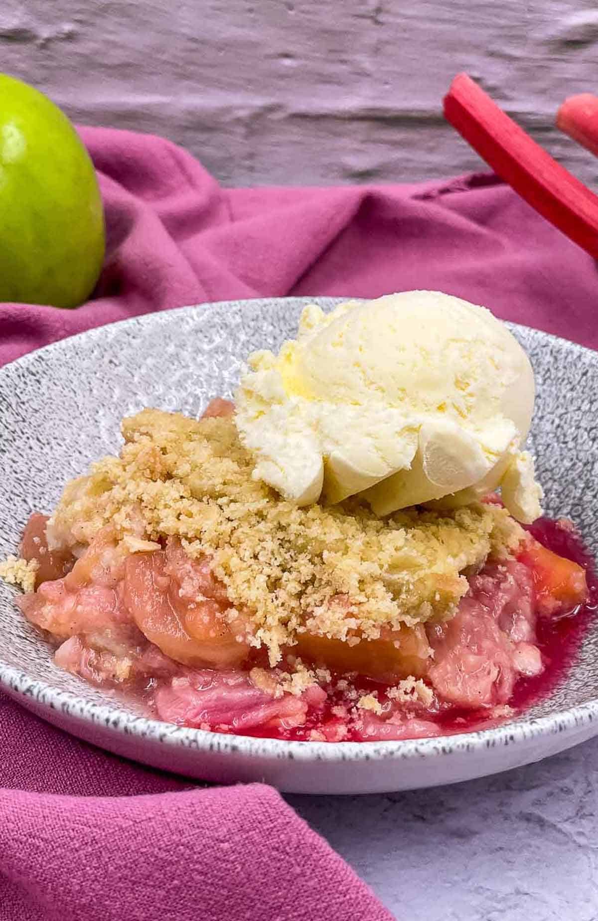Homemade apple and rhubarb crumble with ice cream.