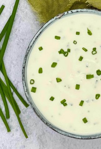 Sour cream and chives dip in a bowl.