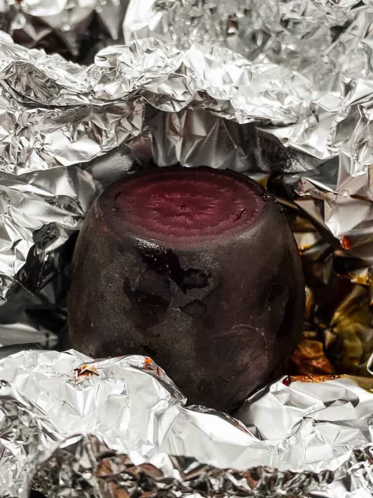 A cooked beetroot wrapped in foil.