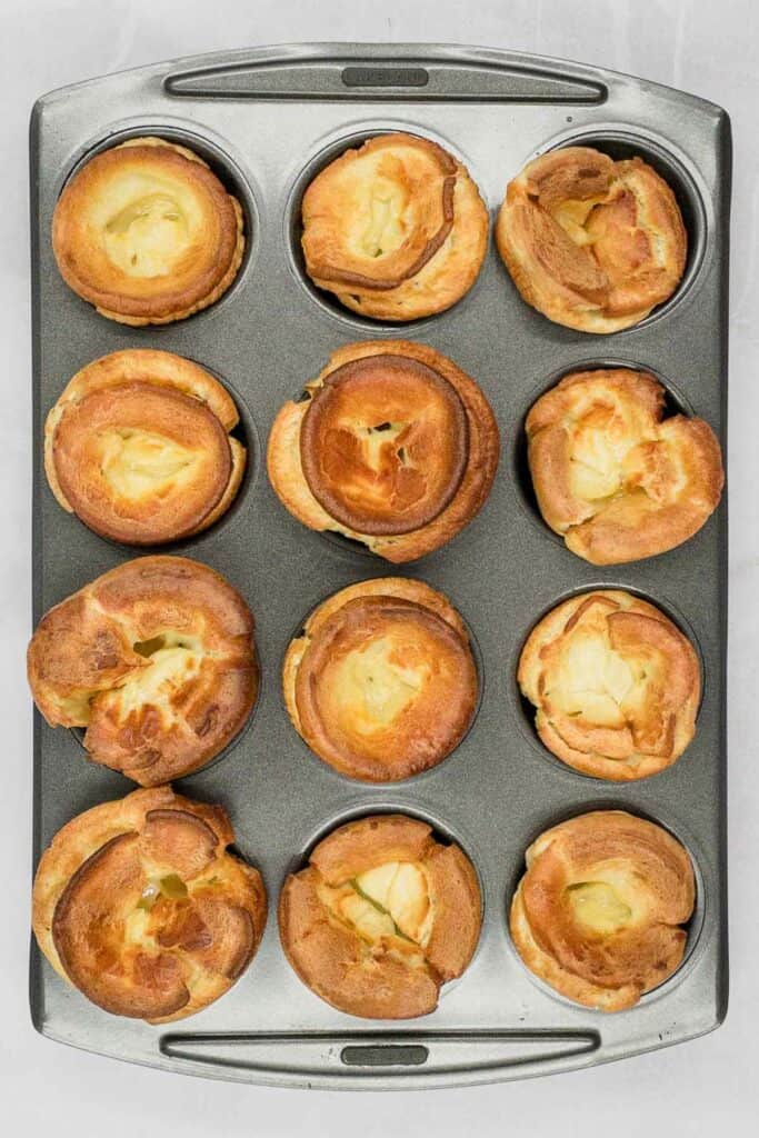 Gluten free Yorkshire puddings in a baking tray.