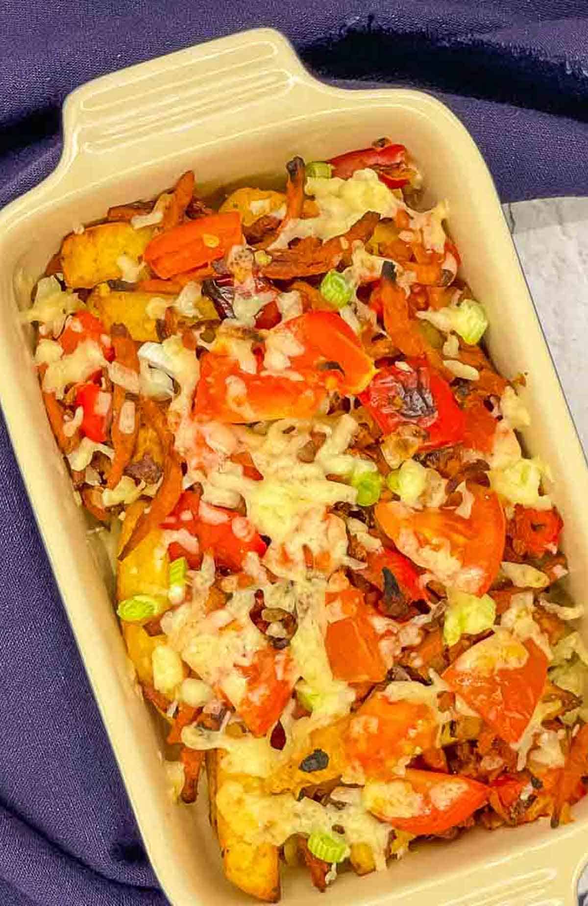 Air fryer dirty fries in an ovenproof dish.