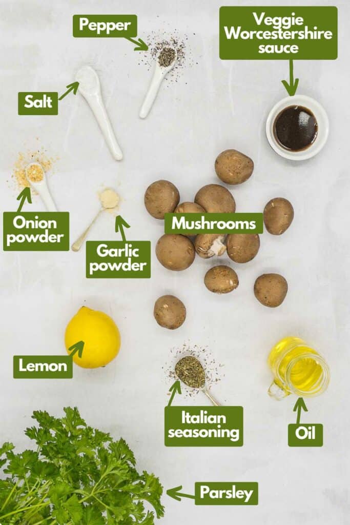Ingredients, black pepper, veggie Worcestershire sauce, baby belle mushrooms, garlic powder, onion powder, lemon, Italian seasoning, olive oil, and fresh parsley.