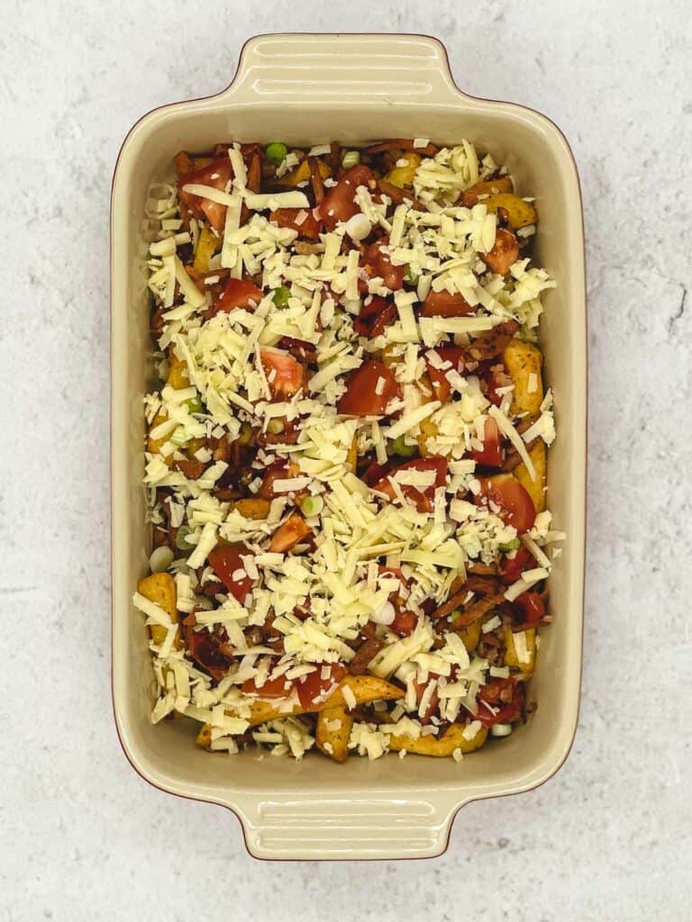 Add grated cheese, tomatoes and scallions.