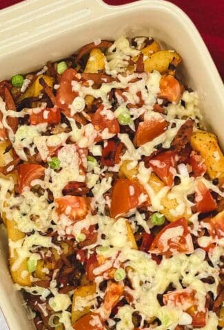 Loaded fries with cheese, tomatoes, green onion, and veggie bacon.