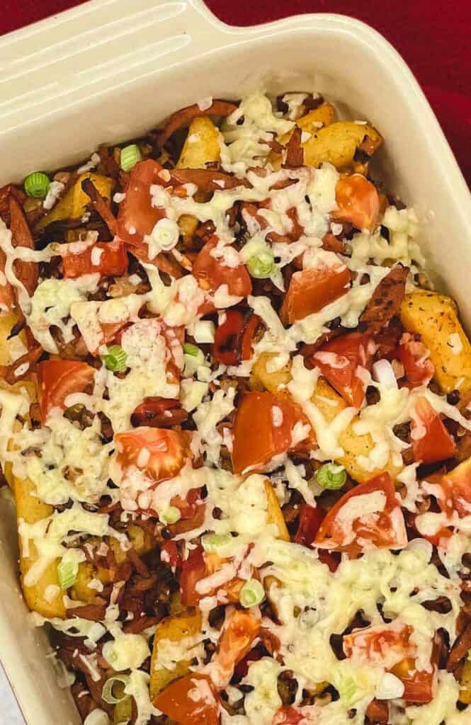 Loaded fries with cheese, tomatoes, green onion, and veggie bacon.