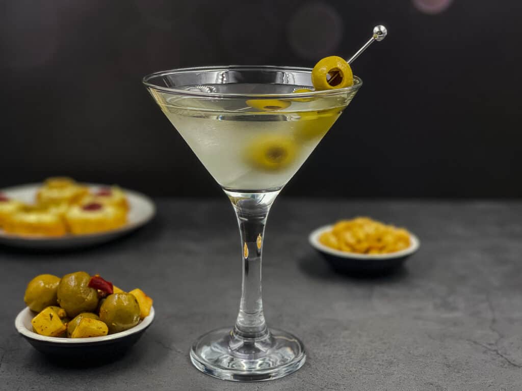 Freshly made dirty martini cocktail with olives.