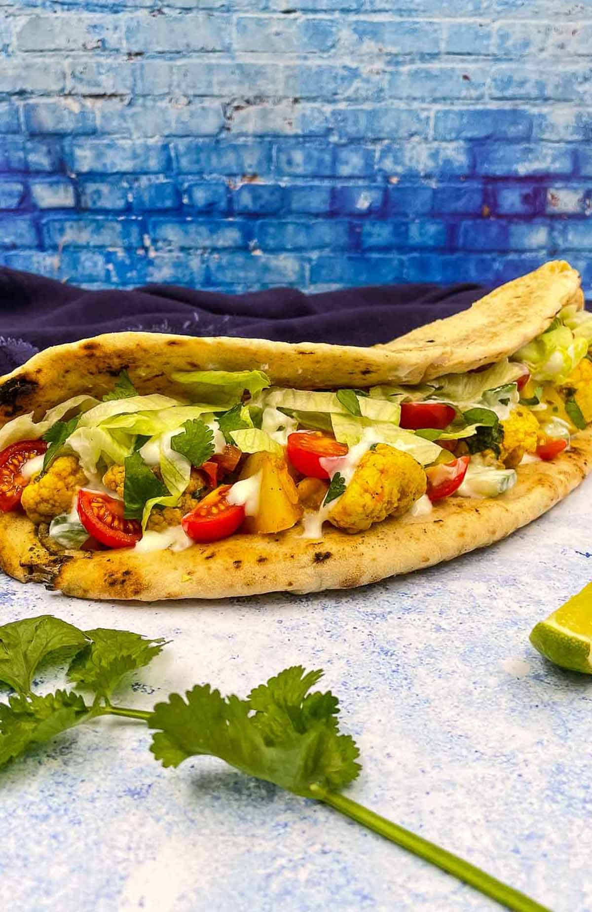 An aloo gobi naanwich with cilantro.