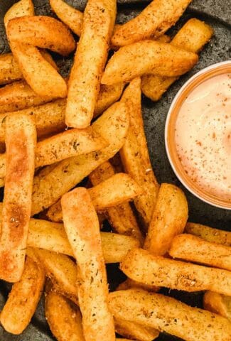 A plate of operi peri fries with sriracha and mayo dipping sauce.