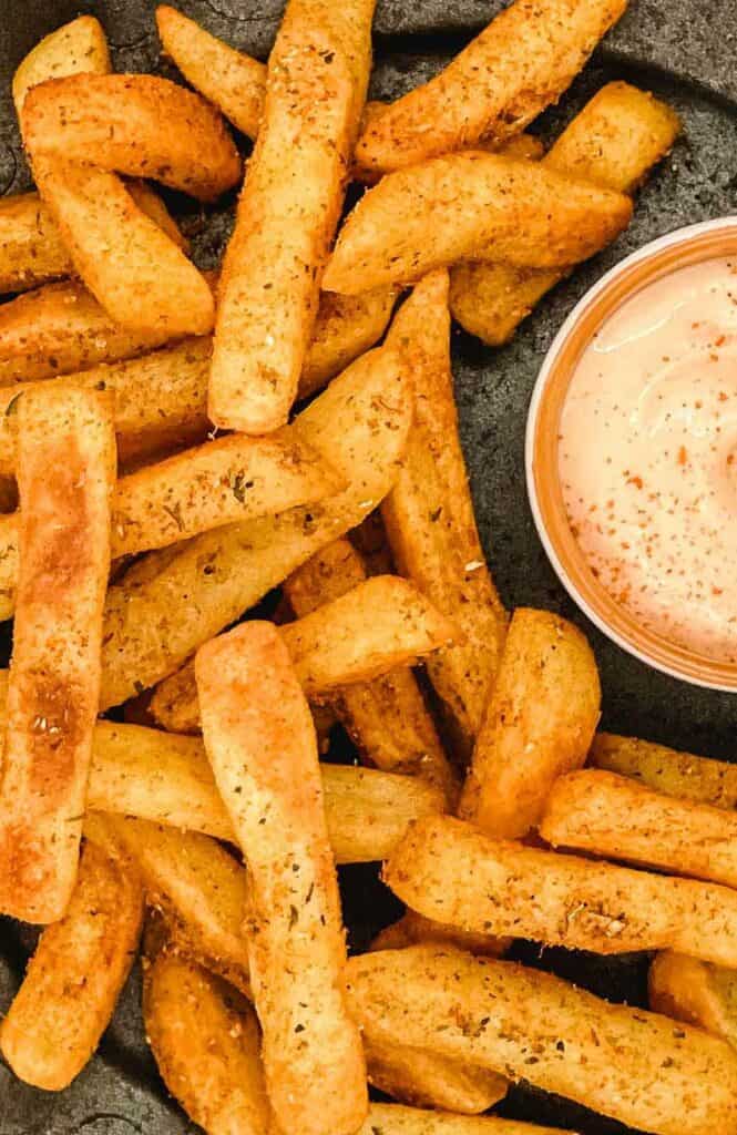 A plate of operi peri fries with sriracha and mayo dipping sauce.