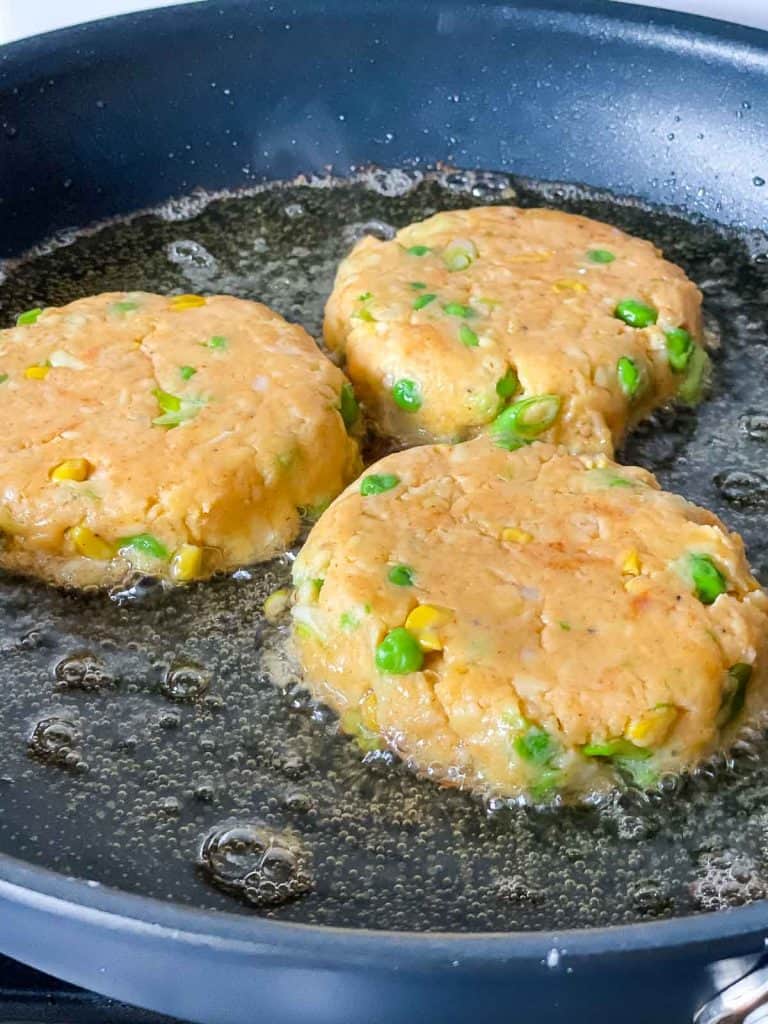 Fritter batter frying in oil.