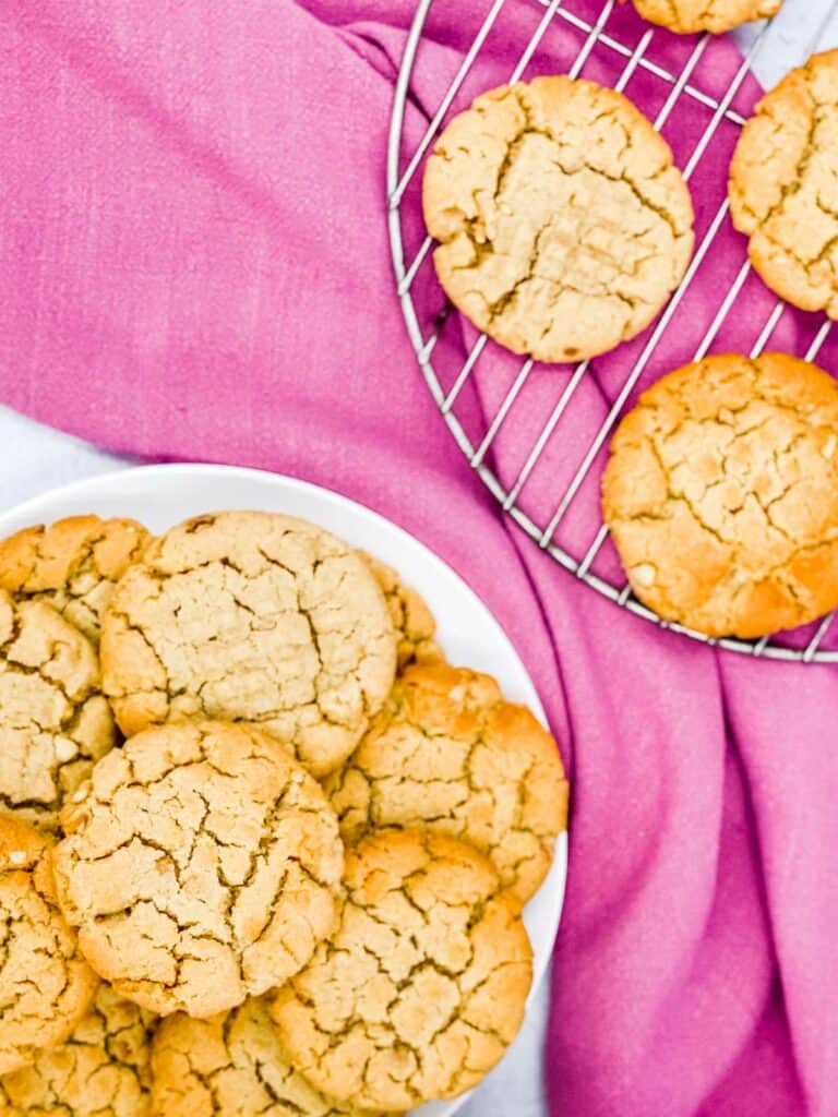 Classic peanut butter cookies on a plate and cooling rack.
