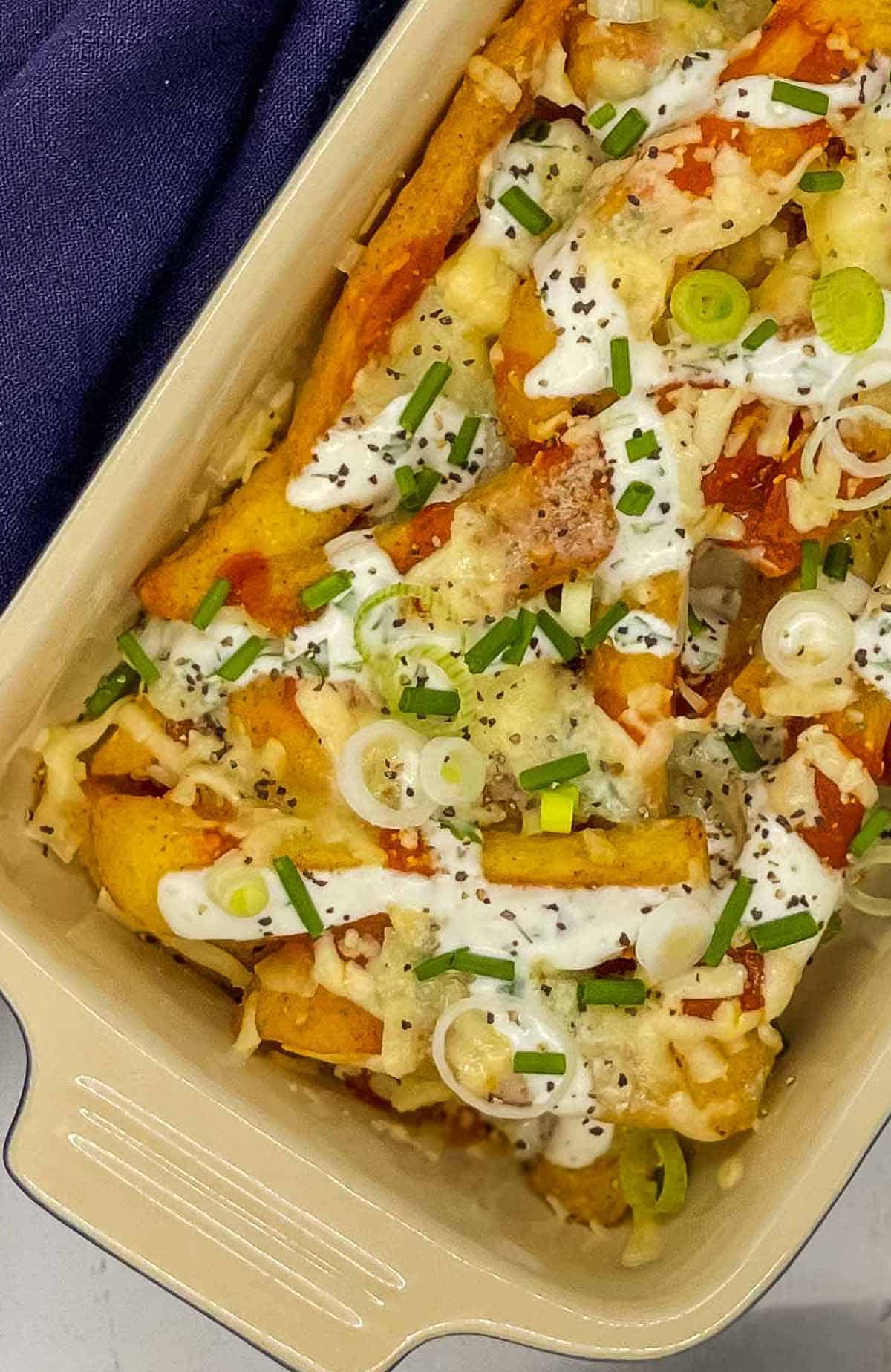 Air fried buffalo fries in an ovenproof dish.