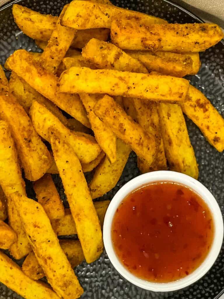 Masala fries, ready to eat with chilli sauce.
