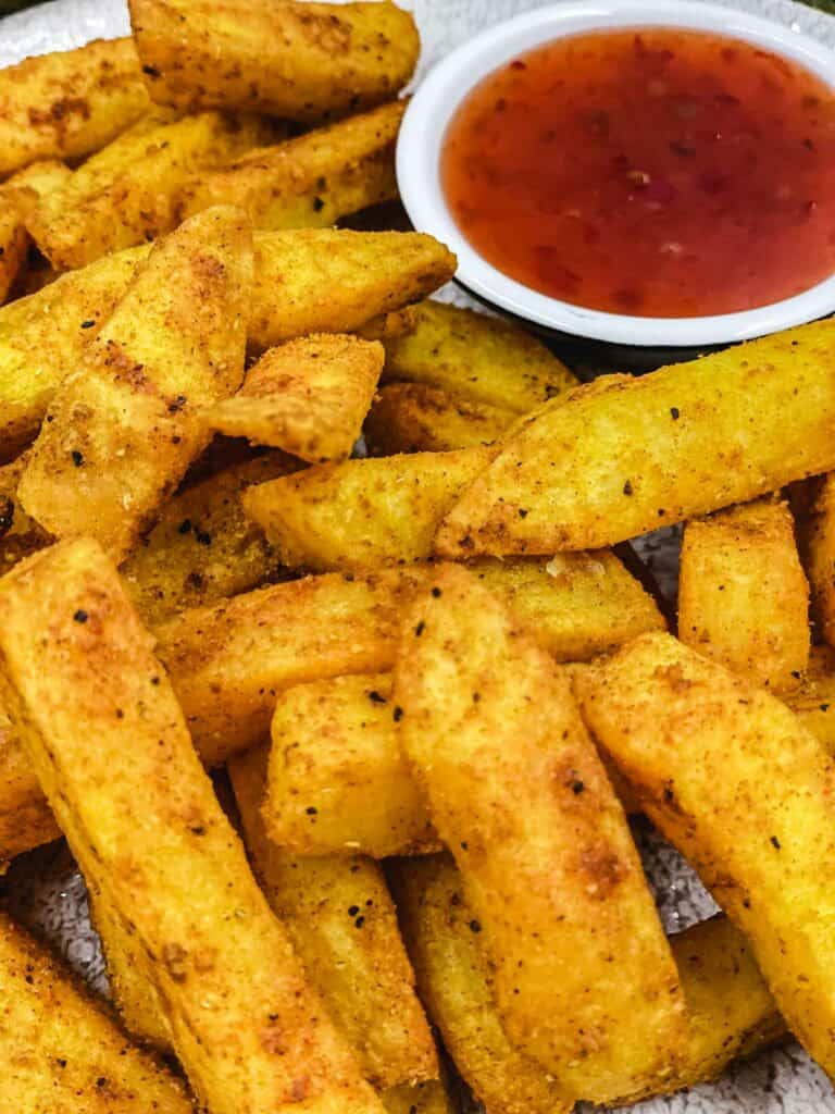 Air fryer masala fries and a dipping sauce.