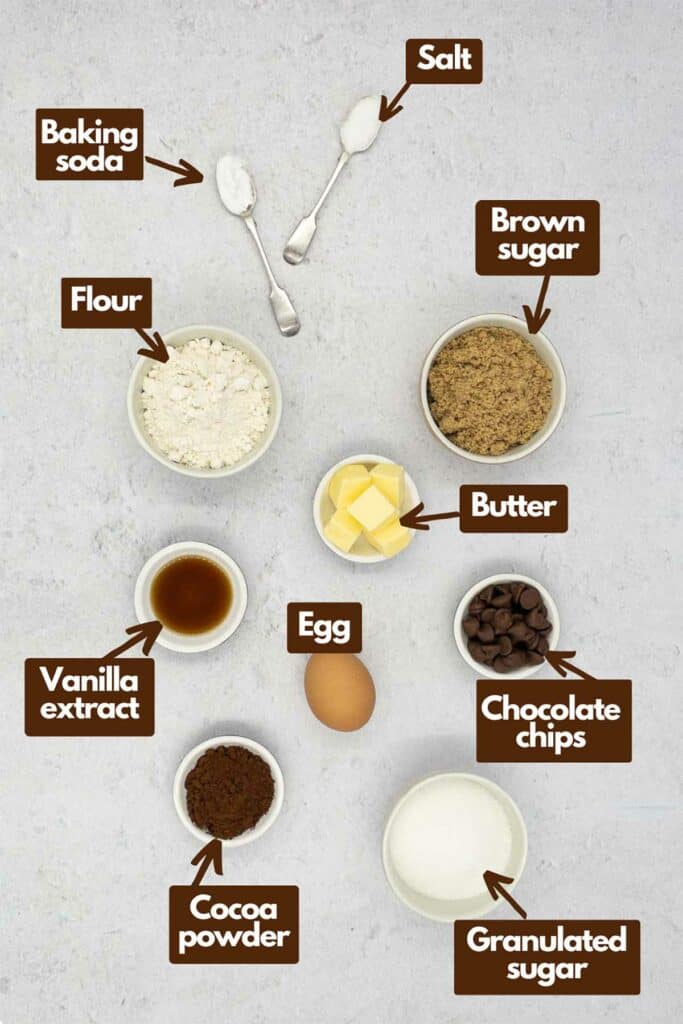Ingredients needed, baking soda, salt, brown sugar, butter, flour, vanilla extract, egg, chocolate chips, granulated sugar, and cocoa powder.