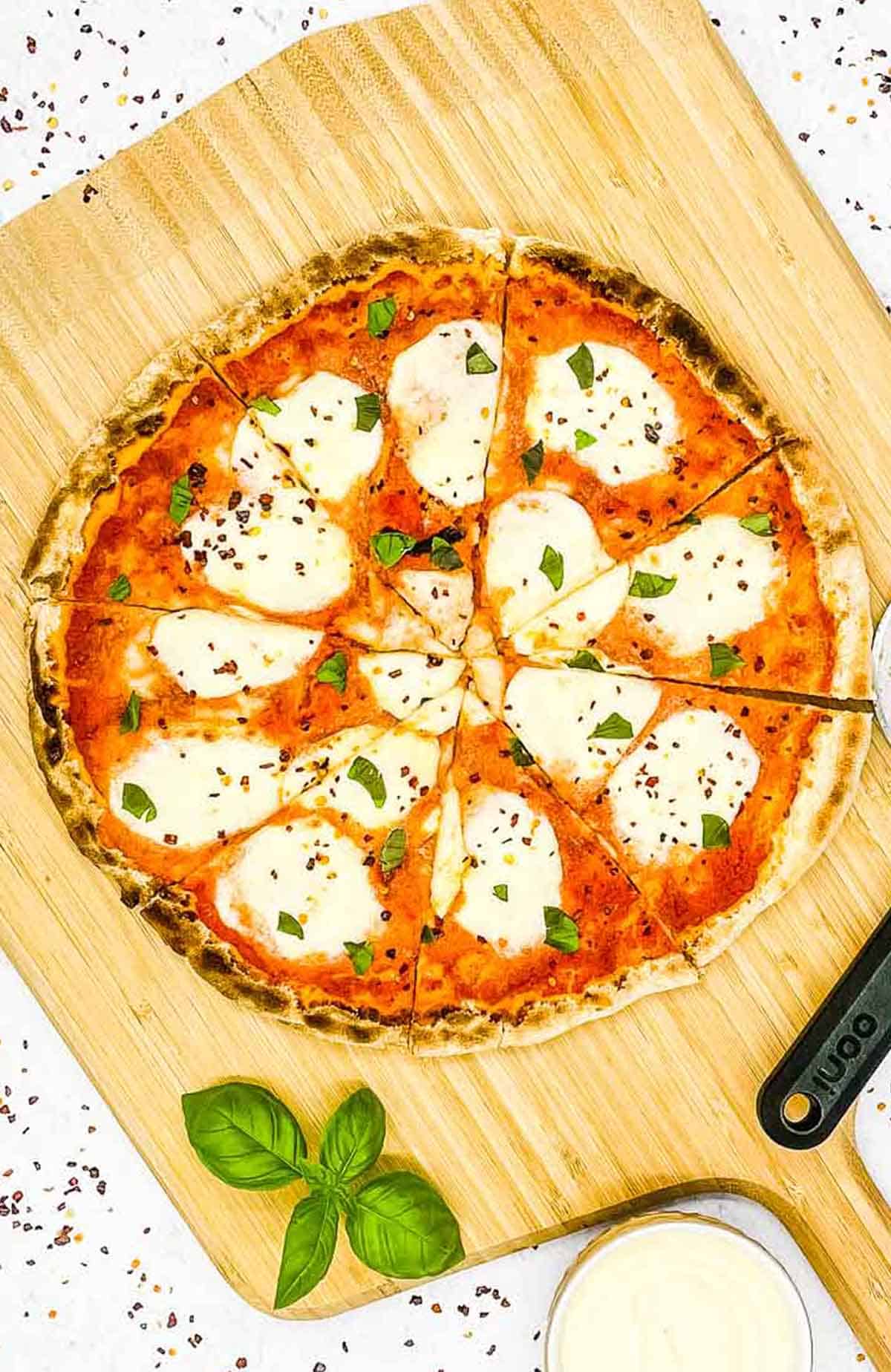 Margherita pizza on a wooden peel.