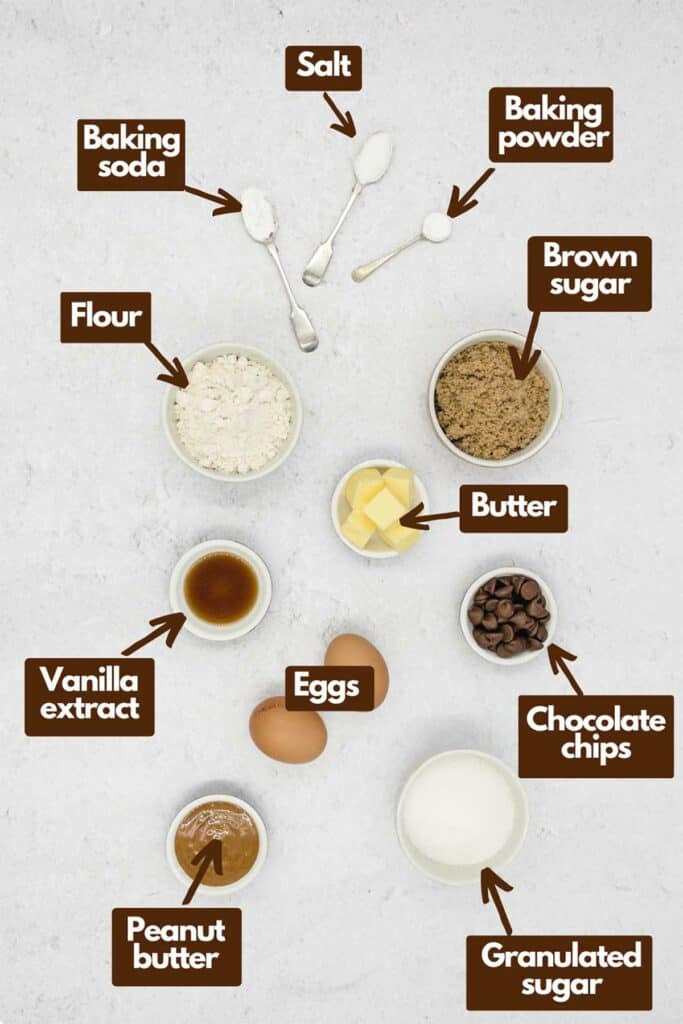 Ingredients needed, flour, baking soda, salt, baking powder, light brown sugar, butter, chocolate chips, granulated sugar, smooth peanut butter, eggs, and vanilla extract.