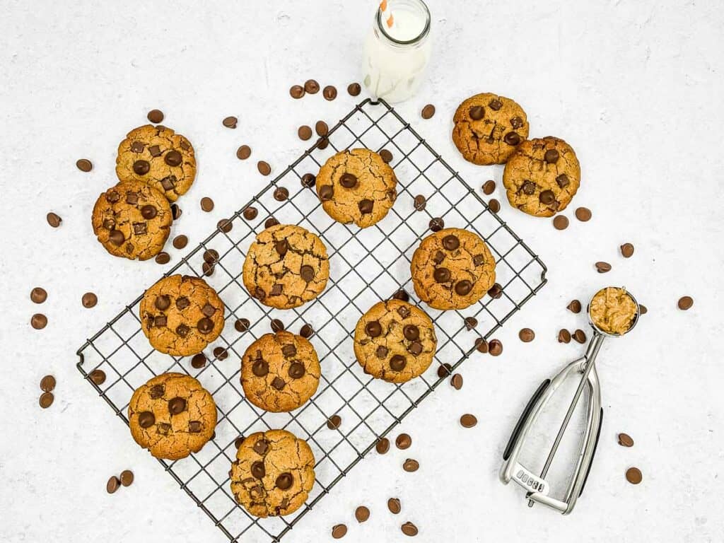A wire rack with Peanut butter chocolate chip cookies on it.
