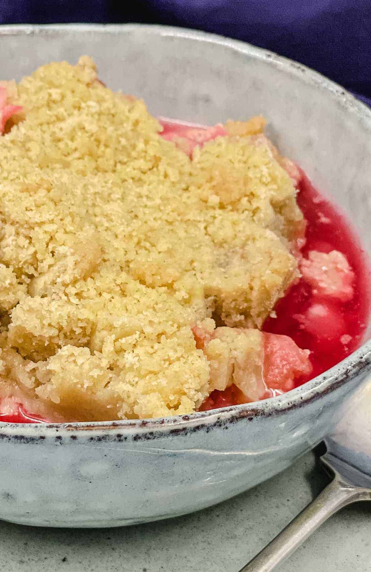 A delicious bowl of homemade vegan rhubarb crumble.
