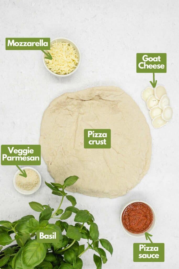 Ingredients needed, mozzarella, goat cheese, pizza crust, vegetarian Parmesan, pizza sauce, and basil.