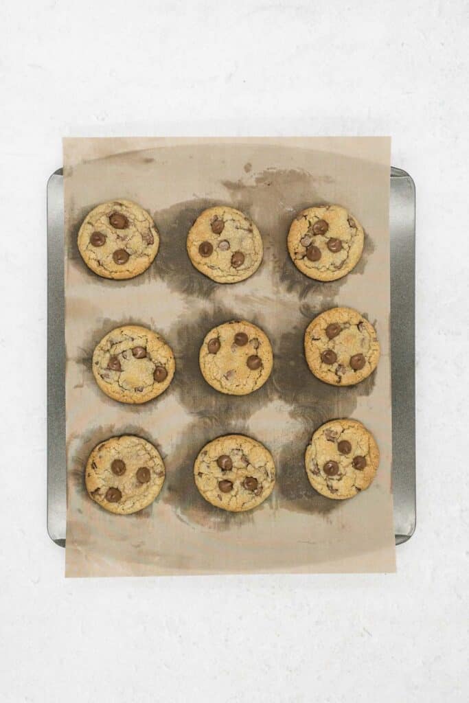 Chocolate chip cookies cooked on a baking sheet.