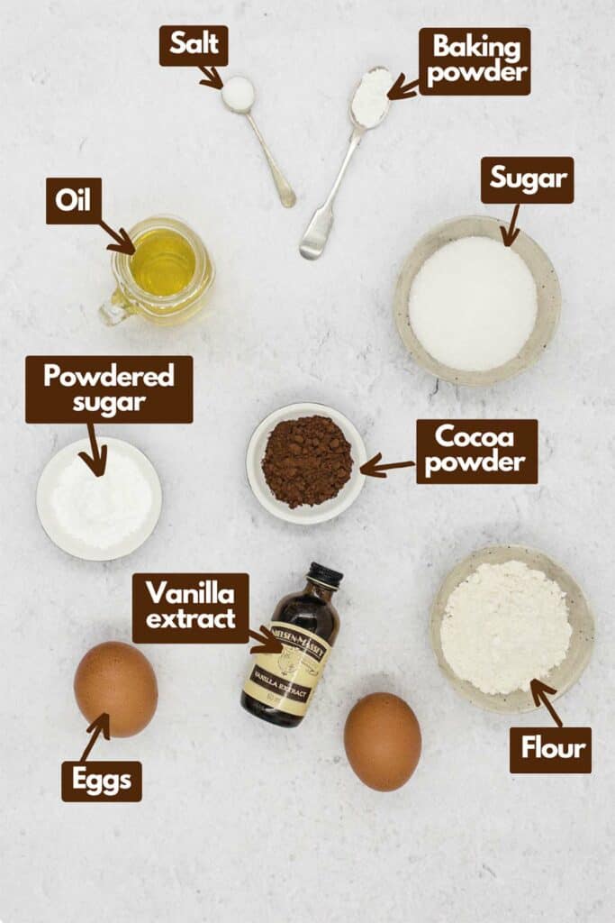 Ingredients needed, vegetable oil, salt, baking powder, granulated sugar, unsweetened cocoa powder, flour, vanilla extract, eggs, and powdered sugar.