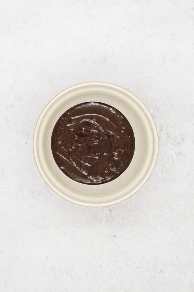 Mix unsweetened cocoa powder, sugar, and vegetable oil.