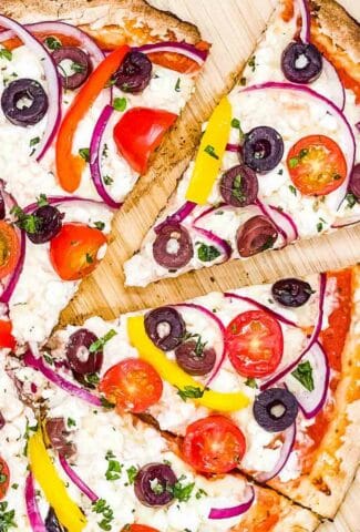 Greek pizza with feta cheese ready to eat.