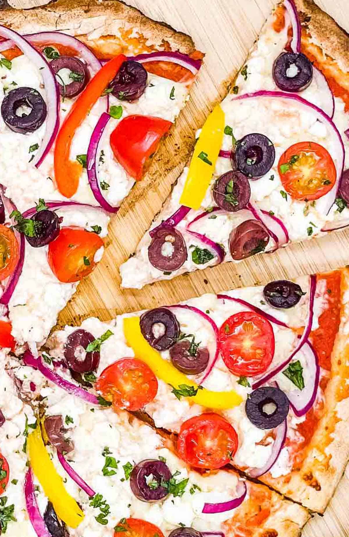 Greek pizza with feta cheese ready to eat.