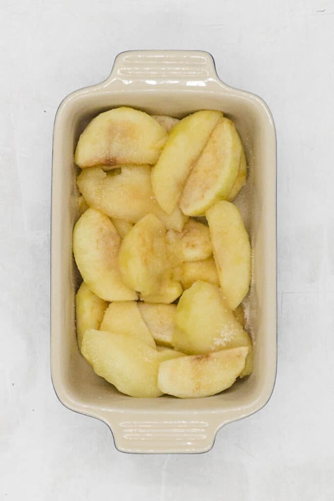Cooked apple slices in an oven proof dish.