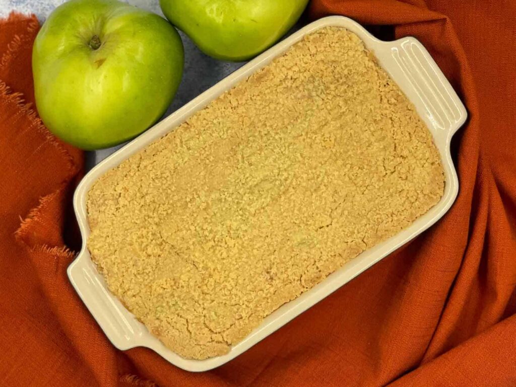 Straight from the oven. a dish full of apple crumble.