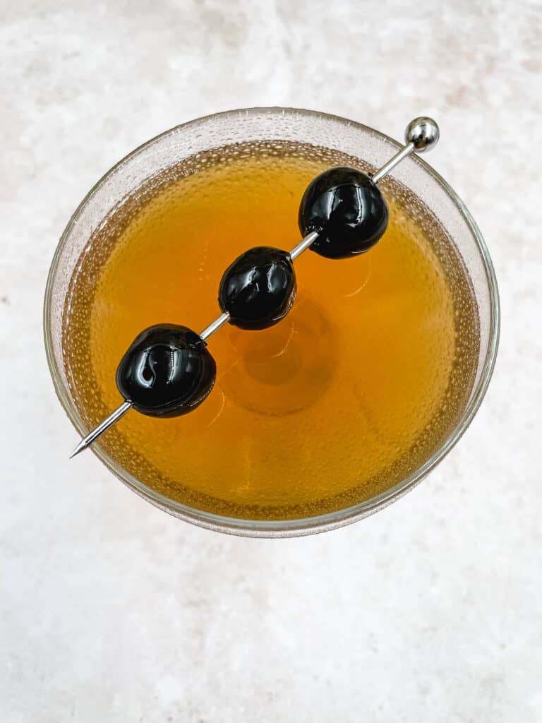 A Manhattan drink from above, with Marischino cherries.