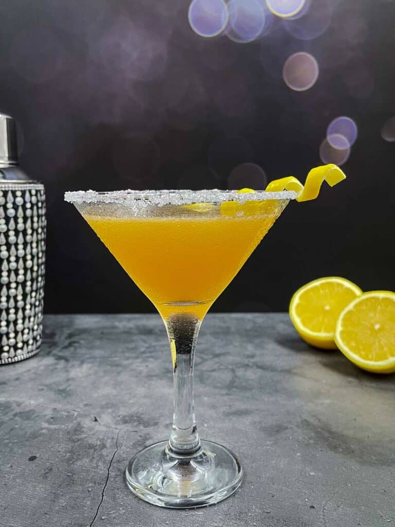 Refreshing glass of homemade sidecar cocktail drink with lemons.