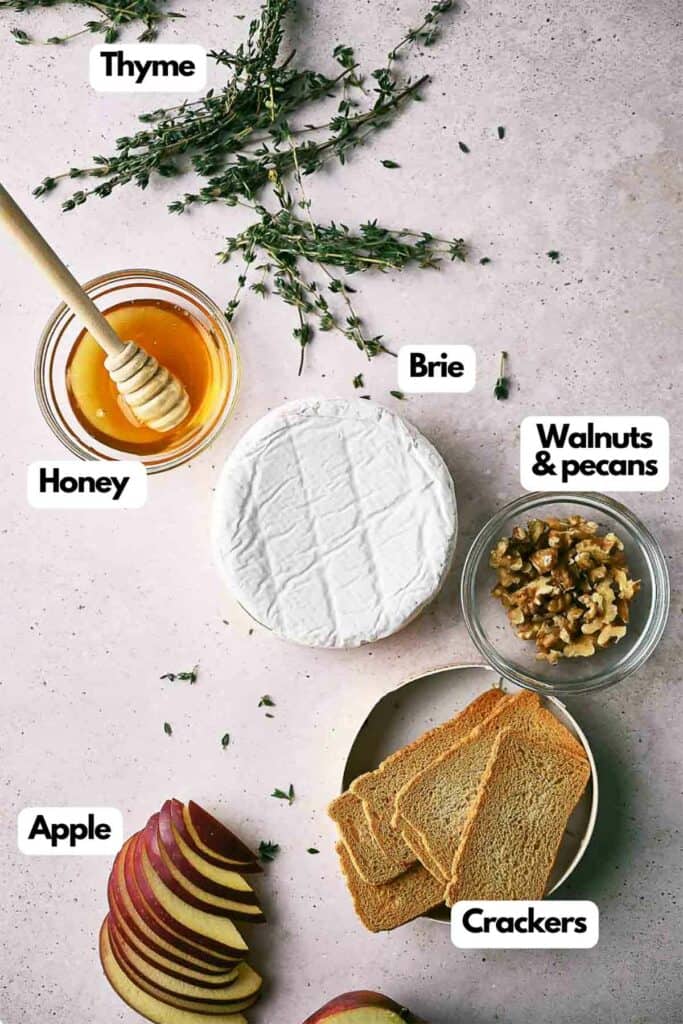 Ingredients needed thyme, honey, brie, walnuts and pecans, crackers, and apple slices.