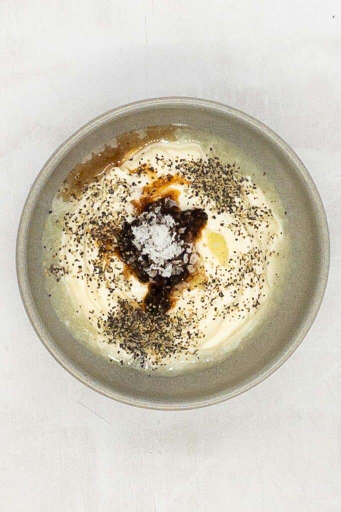 Chipotle chiles pepper, black pepper, and kosher salt in a small bowl.