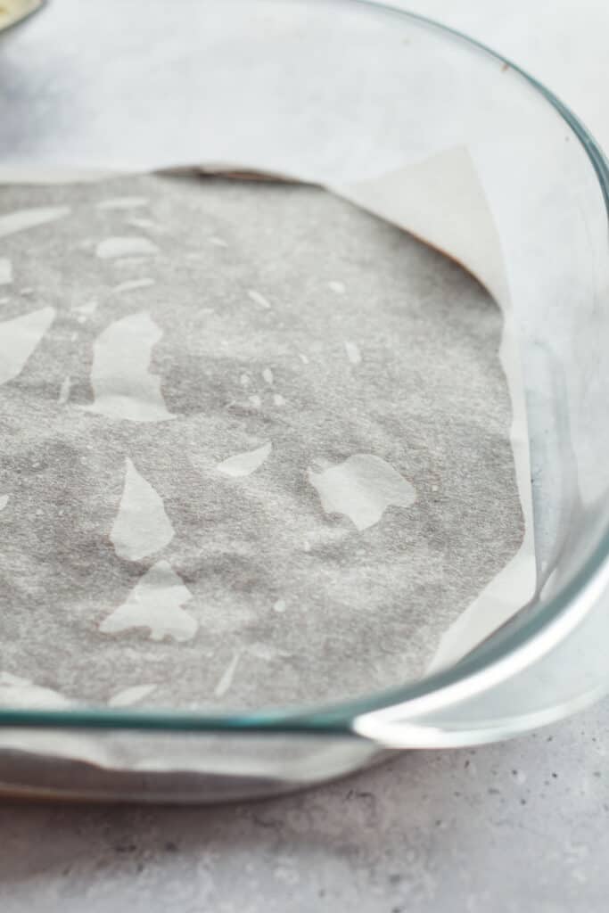 Placing parchment paper on top of the chocolate cream mixture.