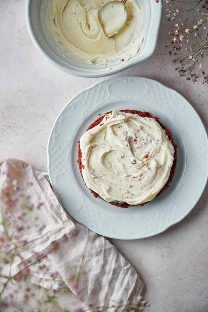 Frosting spread on the first cake layer.