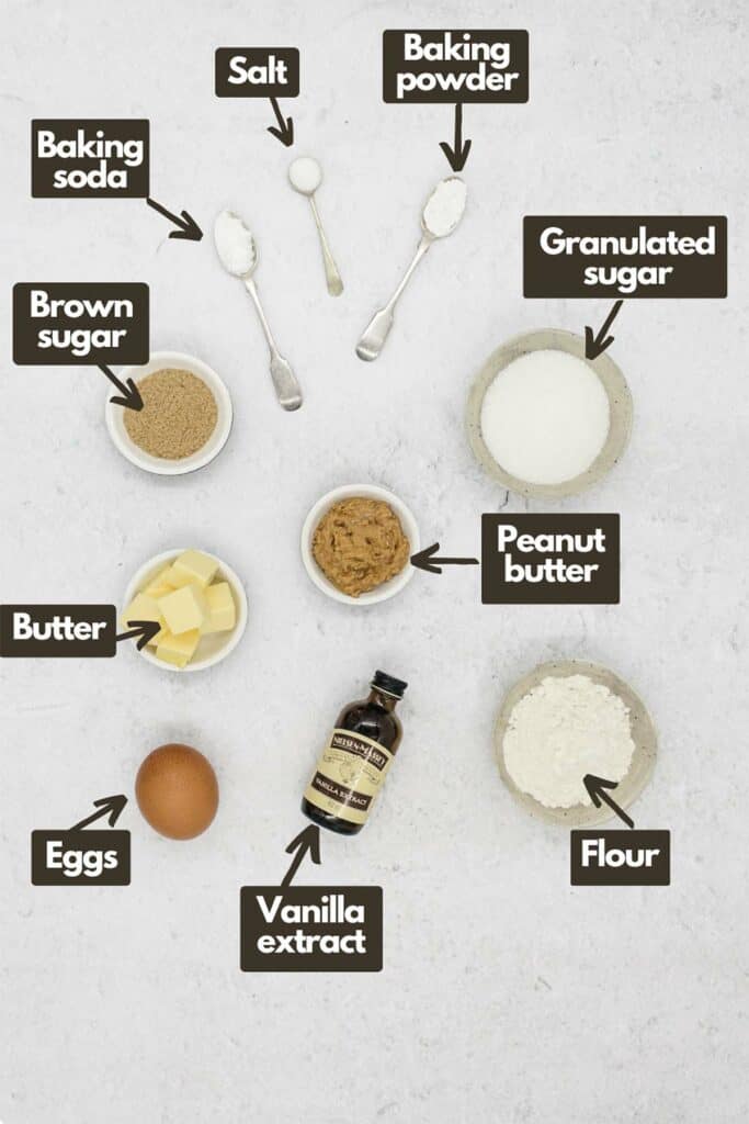 Ingredients needed; brown sugar, baking soda, salt, baking powder, granulated sugar, peanut butter, flour, vanilla extract, eggs, butter, and peanut butter.