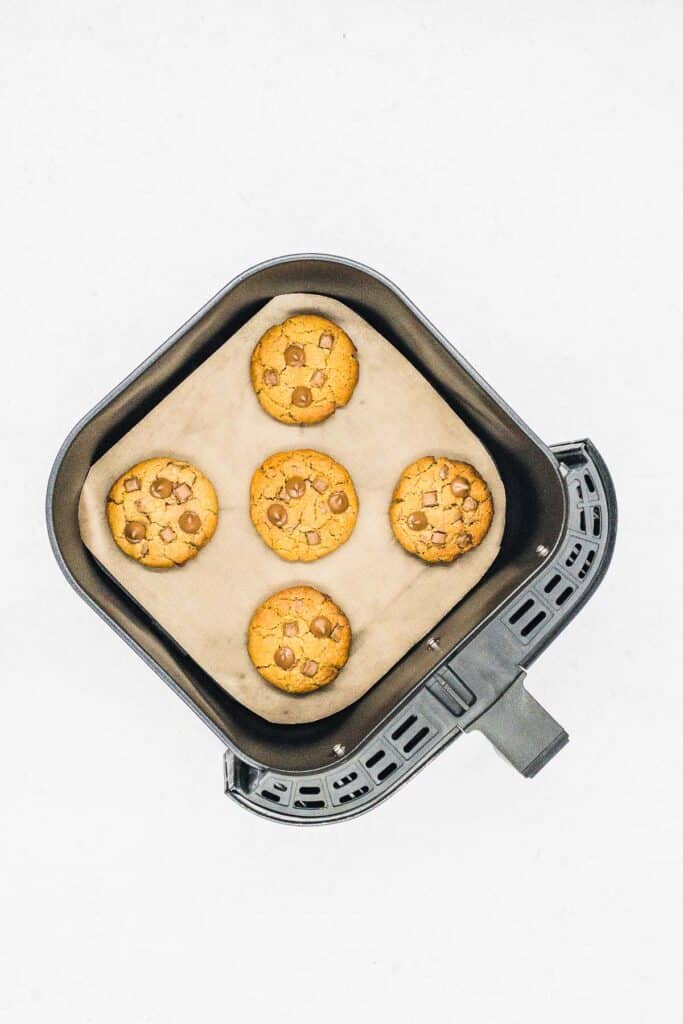 Baked cookies in an air fryer basket.