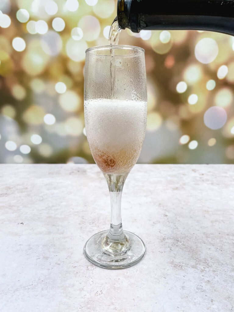 Pouring champagne into a glass.