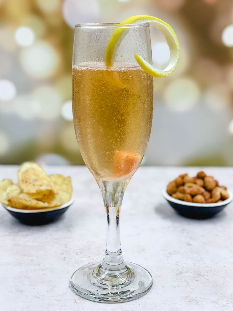 A champagne cocktail with a lemon twist garnish.
