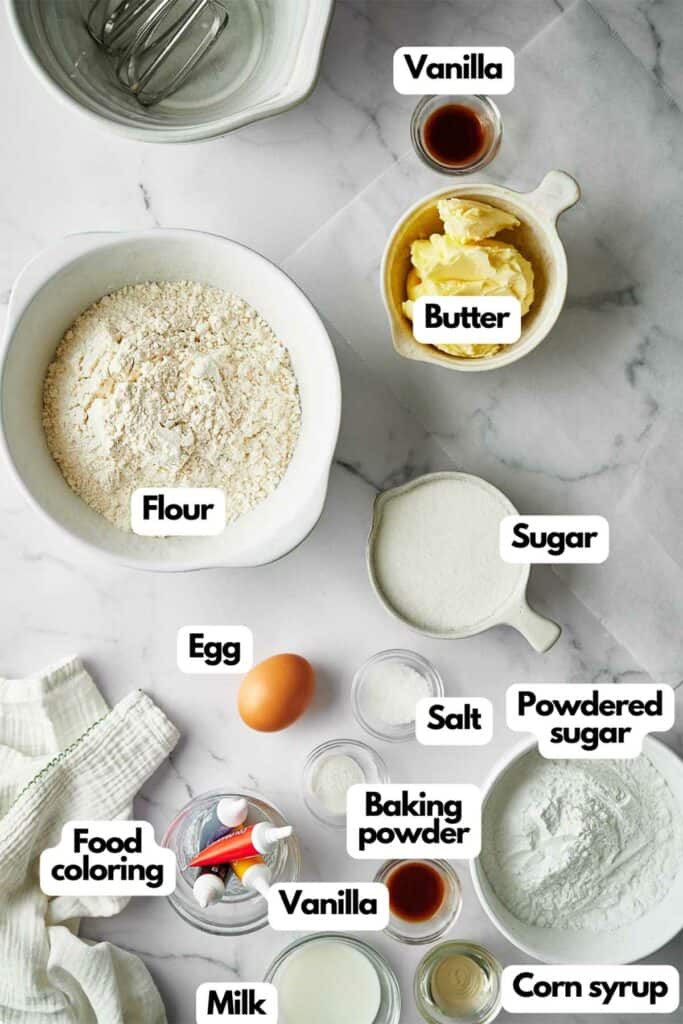 Ingredients needed, flour, vanilla, butter, sugar, powdered sugar, corn syrup, salt, baking powder, egg, milk, and food coloring.