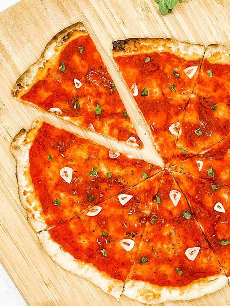 Marinara pizza on a board.