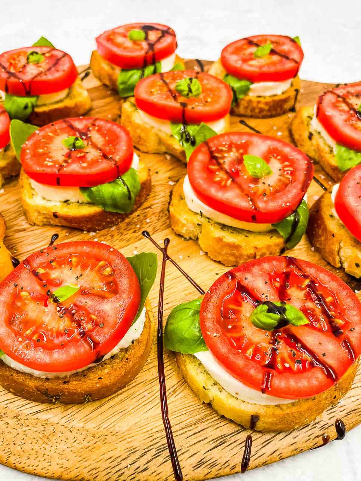 Caprese appetizers ready to eat on a serving platter.