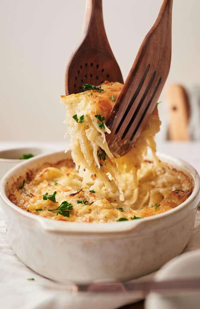 Dishing up a serving off homemade hashbrown casserole.