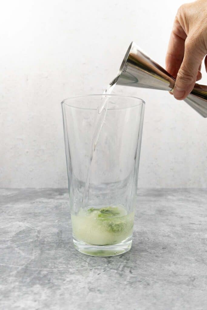 Adding tequila to cocktail.